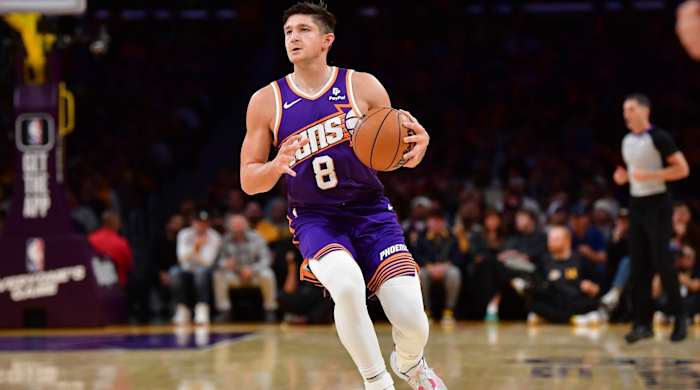 Suns guard Grayson Allen pulls up with the ball in a game.